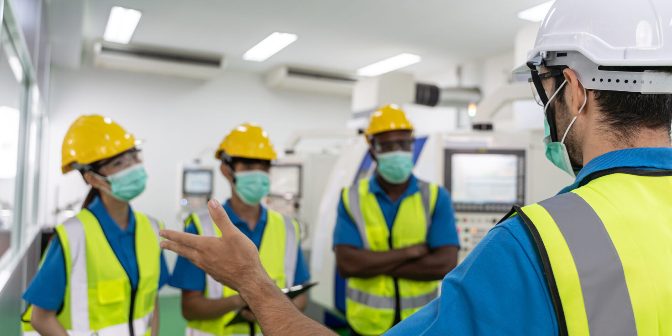 Factory workers meeting before work And put on a mask